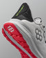 Gray and red running shoe with visible brand logos on a gray background