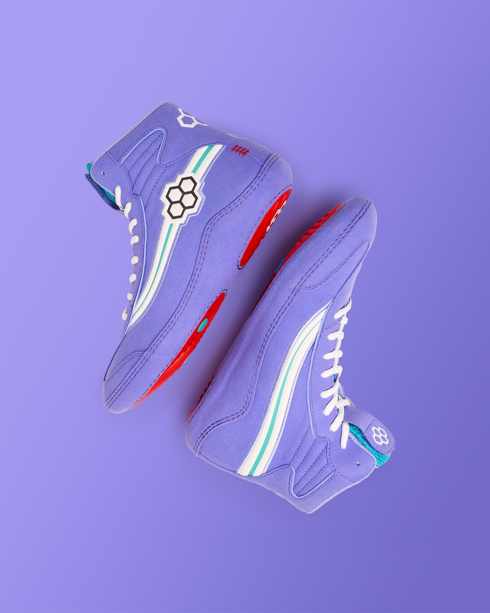 A pair of vibrant lavender high-top sneakers featuring bold red soles white laces and playful design accents