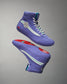 This image features a pair of stylish purple high-top sneakers showcasing a unique design with a geometric motif on the side and a vibrant sole