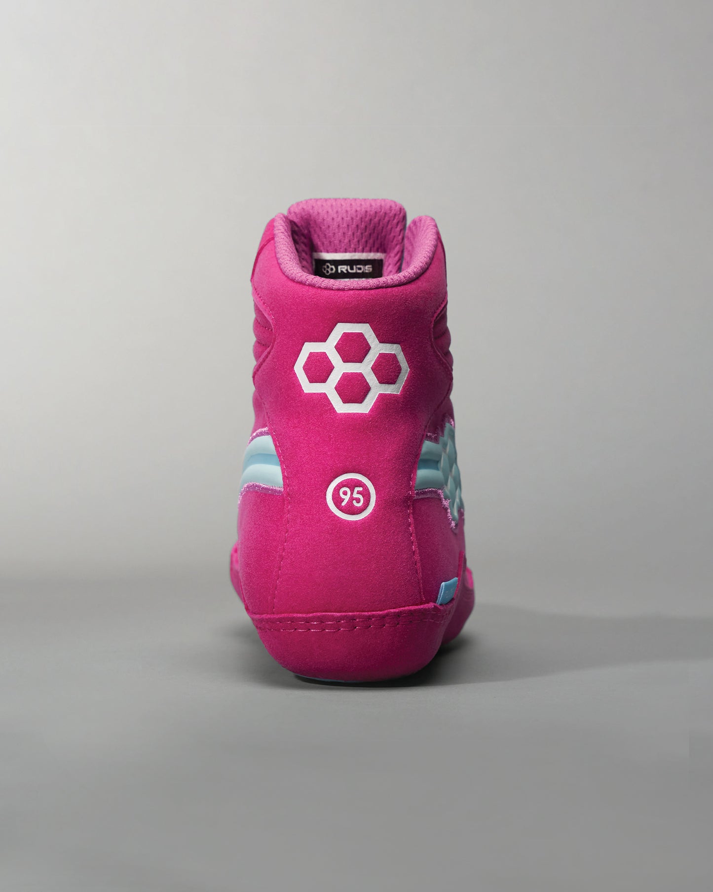 A vibrant pink athletic shoe with a modern design featuring a unique hexagonal logo and a cool blue accent on the sides