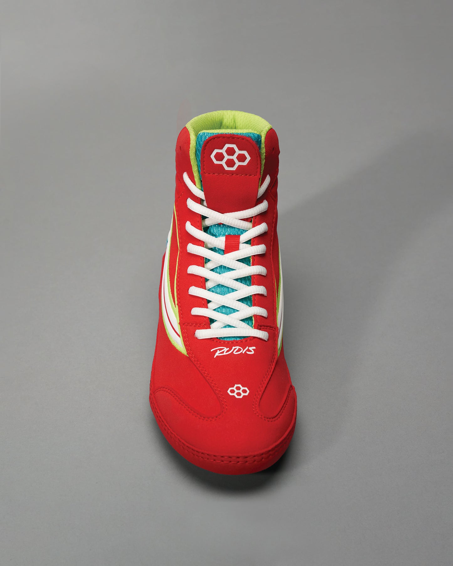 This image showcases a vibrant red athletic shoe with white laces and colorful accents designed for performance in sports or casual wear