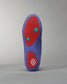 This image features the sole of a unique purple shoe with red and teal details highlighting its modern design and distinctive tread pattern