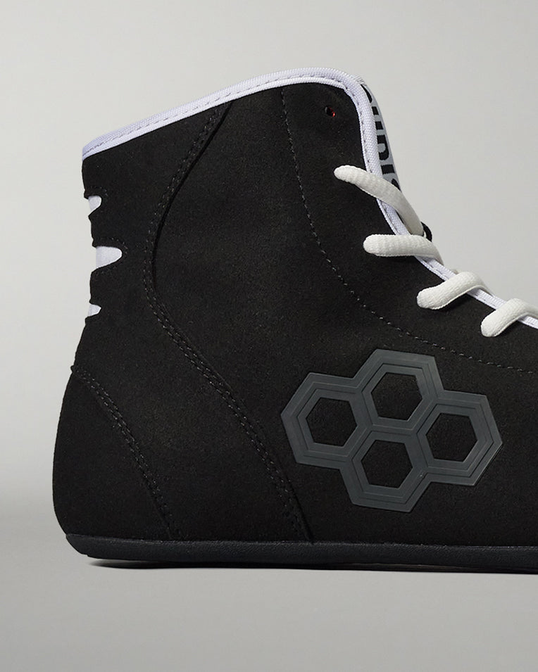 Cropped image of the RUDIS international wrestling shoe - black/white on a grey background. 