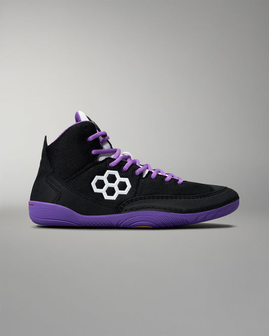 Black high-top sneaker with purple accents and a white logo on a gray background