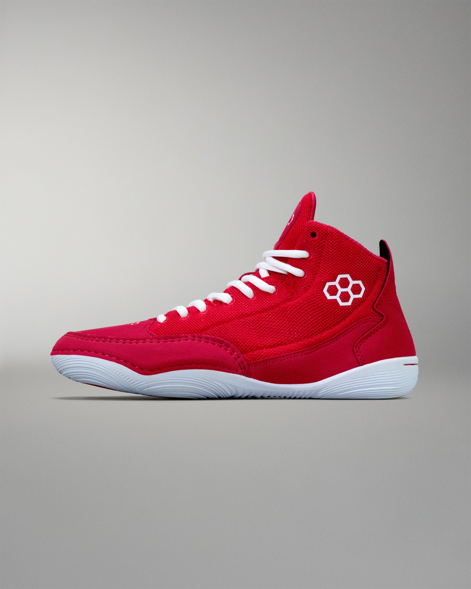 Inside view - A pair of crimson red adult wrestling shoes with white laces and a distinctive flower logo on the side.