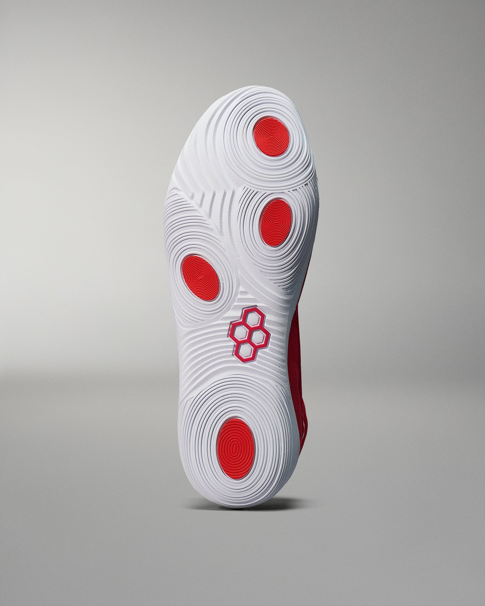 White wrestling shoe sole bottom view with RUDIS hex logo
