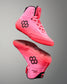 Pink wrestling shoes with black hexagonal logo on a gray background