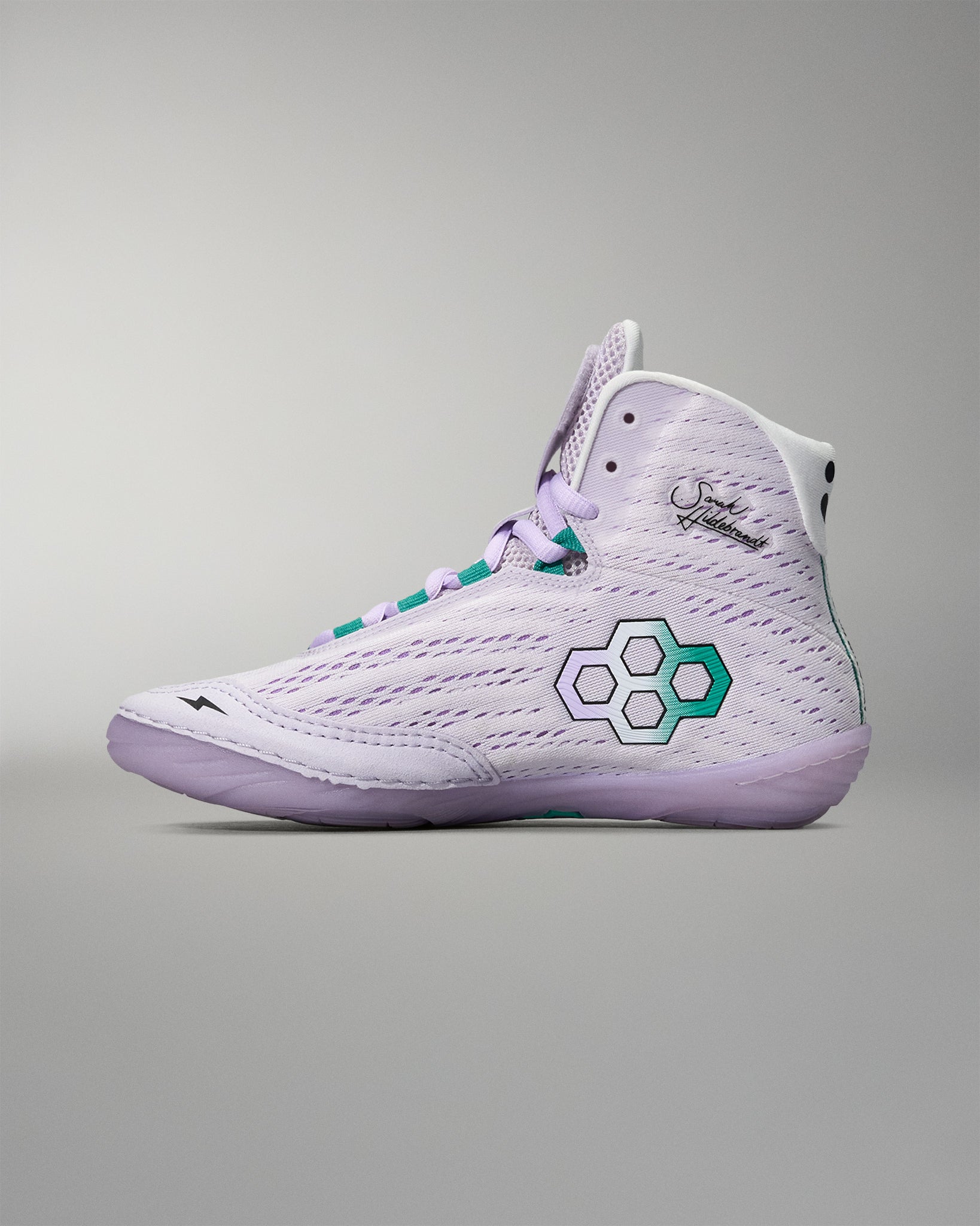 White high-top sneaker with a green logo on a gray background