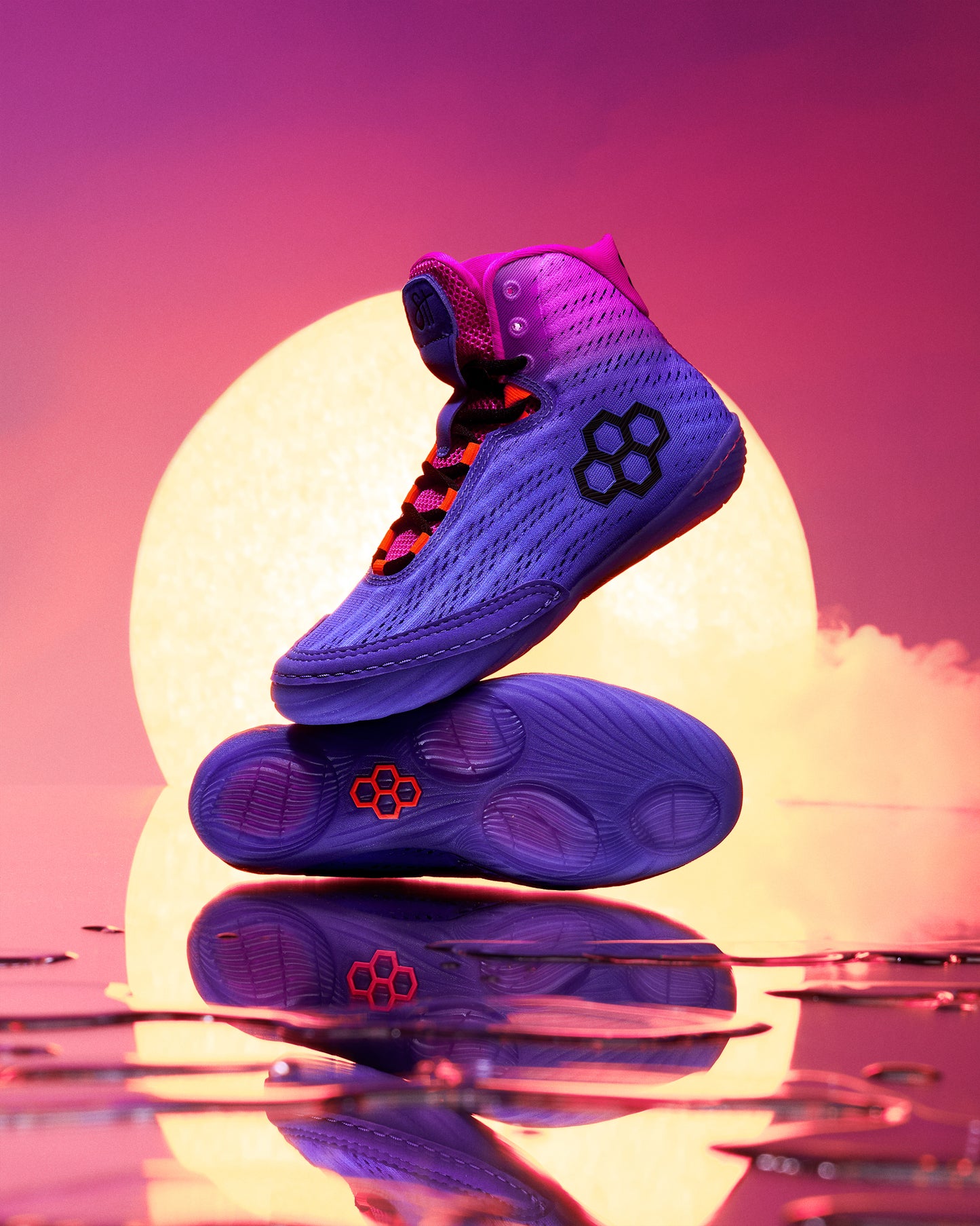 Purple wrestling shoe with a unique design on a reflective surface with a colorful background