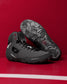 Black wrestling shoes on a red background