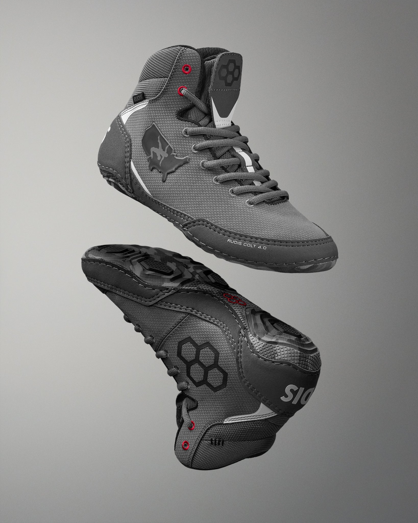 Gray wrestling shoes with black accents on a gray background
