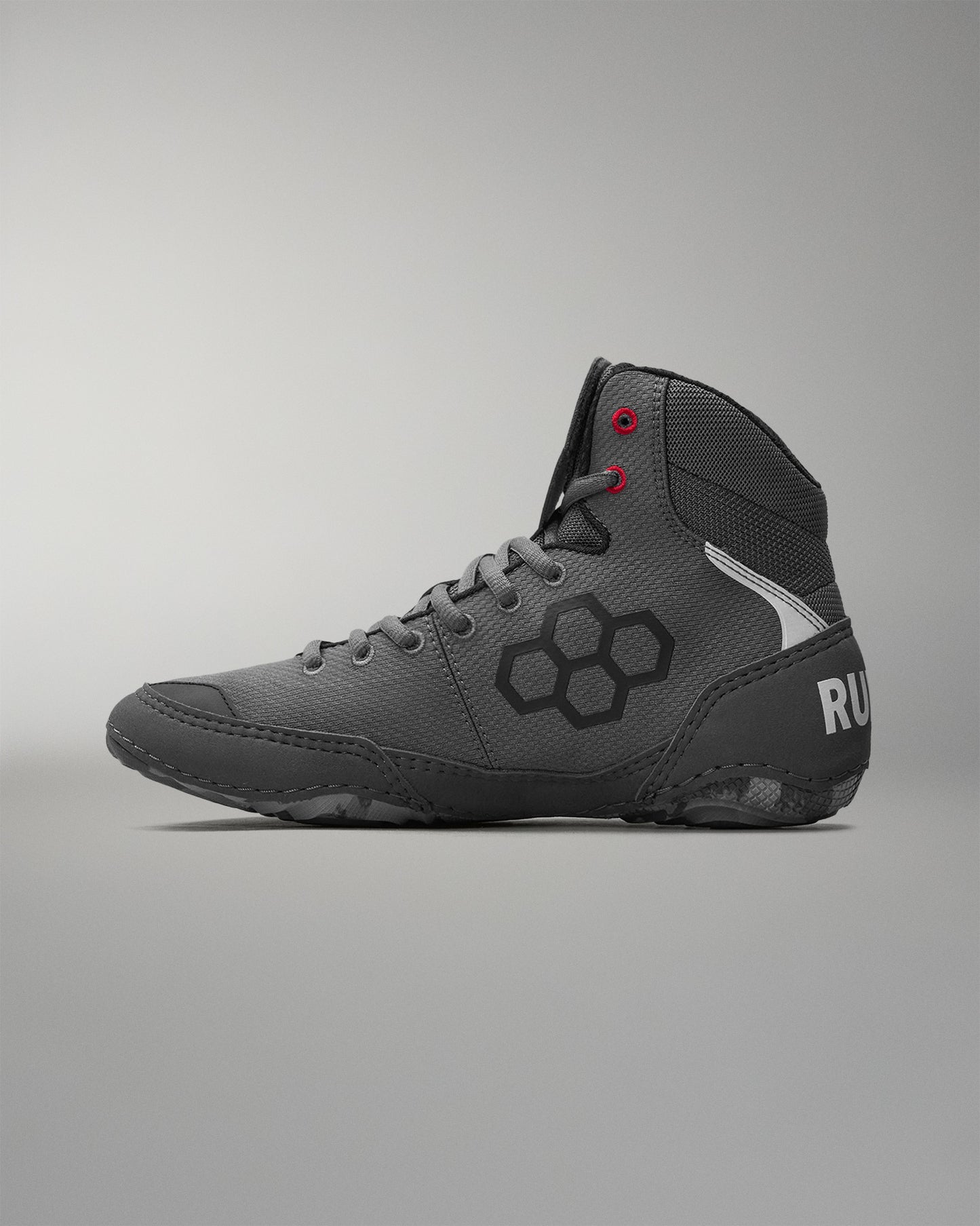 Gray wrestling shoe with a 'RUDIS' brand logo on a gray background