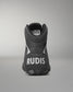 Black wrestling shoe with 'RUDIS' branding on a gray background