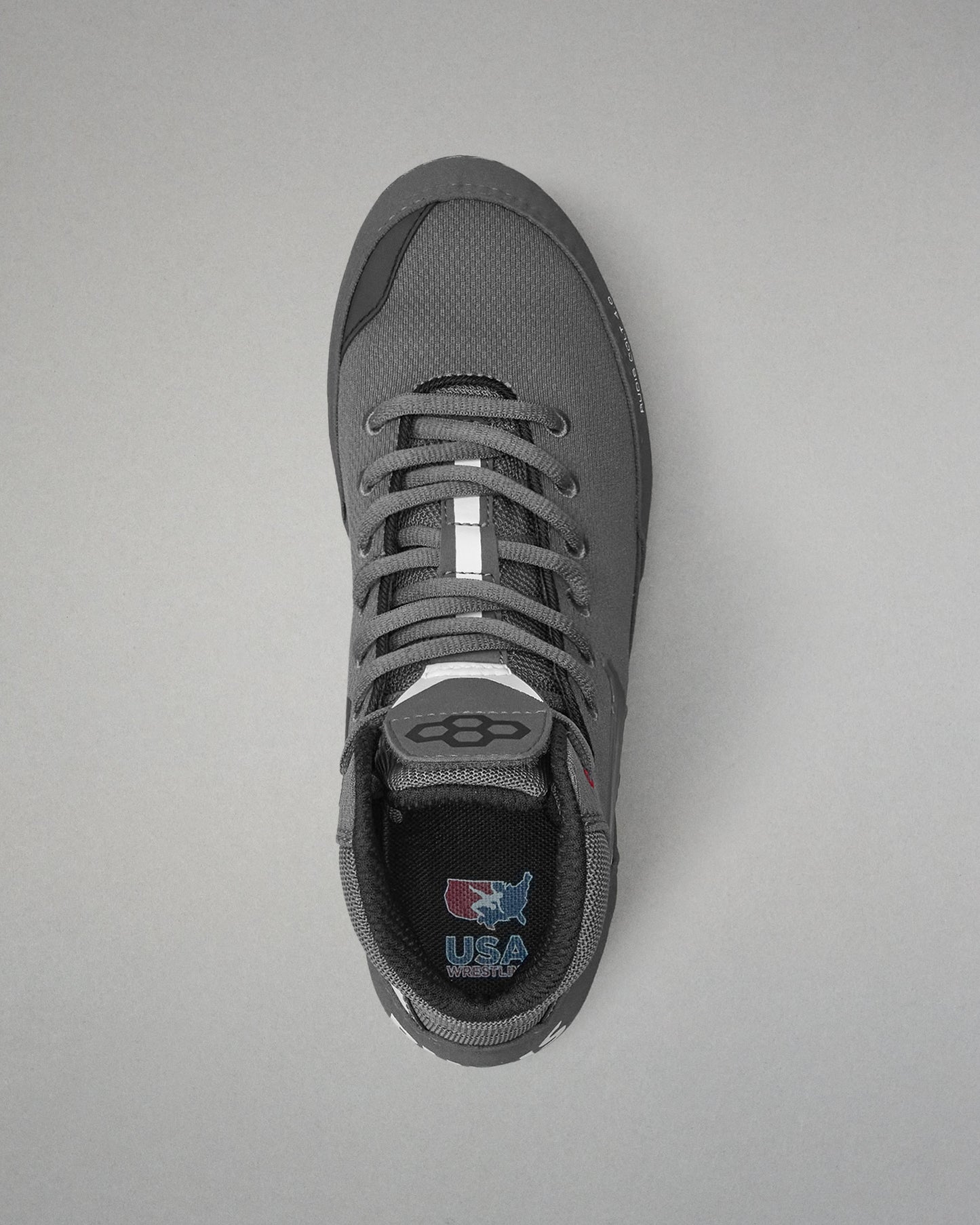 Gray wrestling shoe with a visible brand logo on a gray background