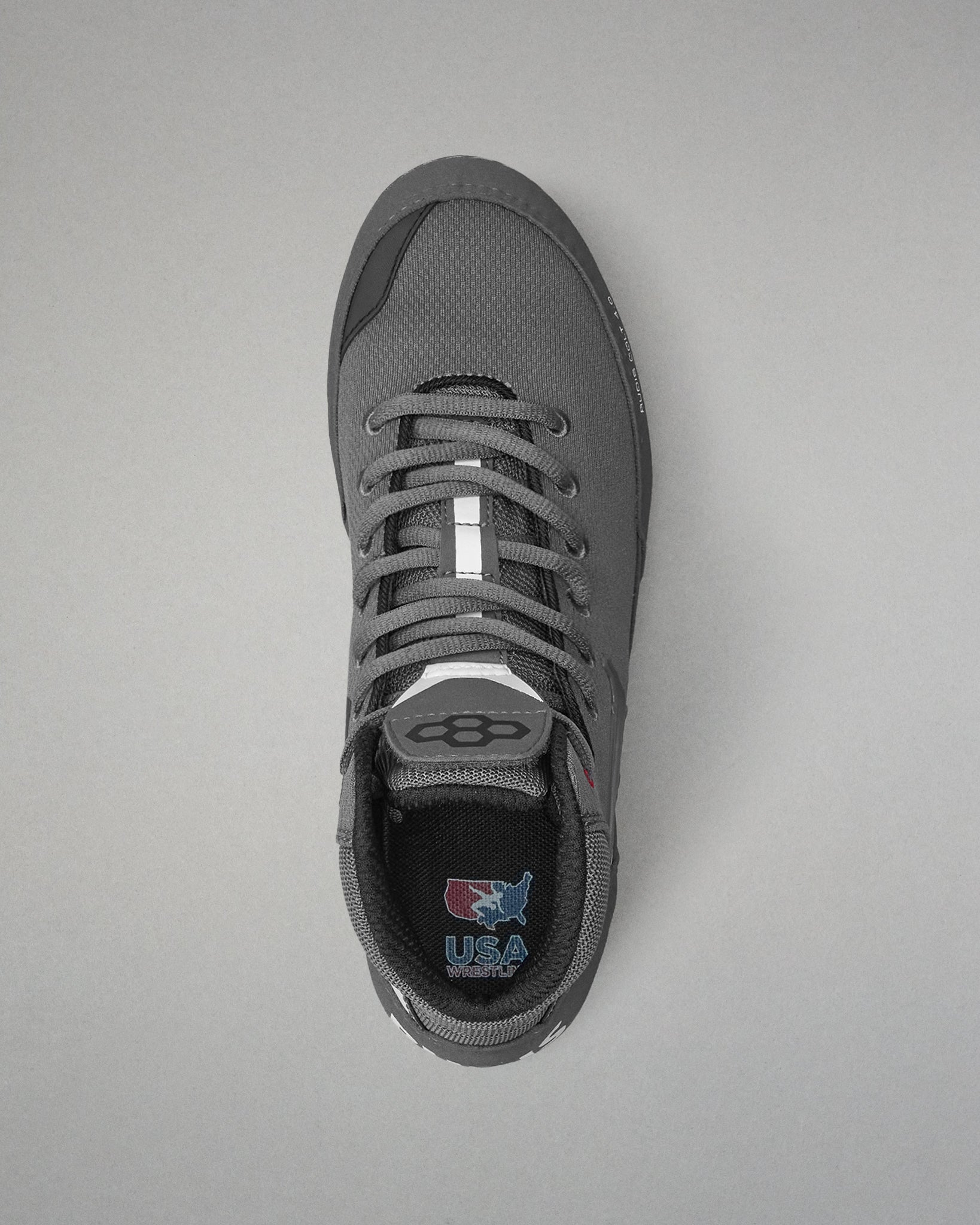Gray wrestling shoe with a visible brand logo on a gray background