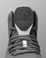 Gray wrestling shoe with laces on a gray background