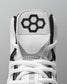 White Wrestling shoe with black hexagonal logo on a gray background