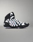 A high-top athletic wrestling shoe in black and white with a bold geometric pattern and a colorful circular graphic on the side, shown against a neutral gray background.