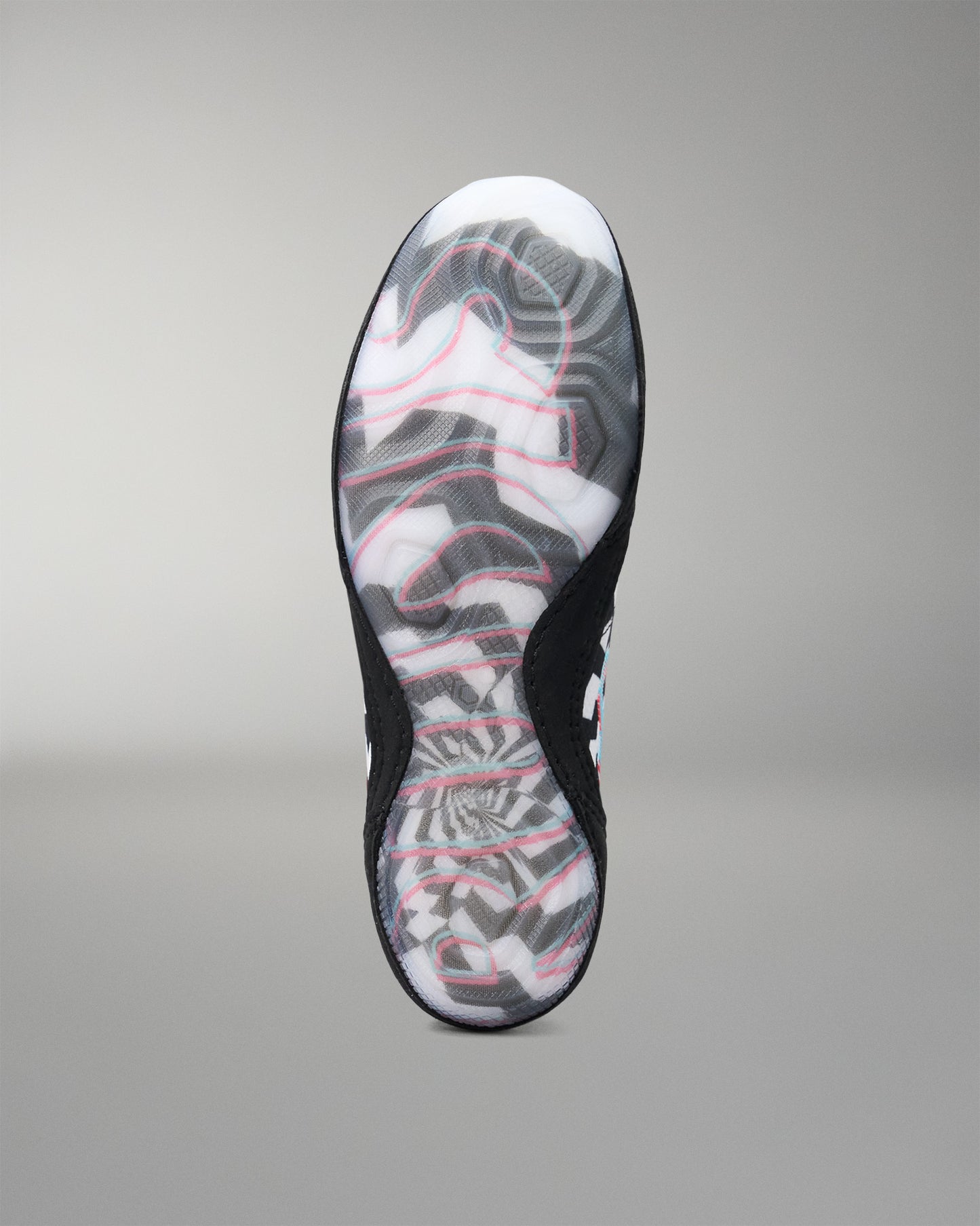 The outsole of a black athletic wrestling shoe with a white and gray abstract pattern and pink accent lines, shown against a neutral gray background.
