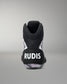 A black high-top athletic wrestling shoe shown from the back, featuring a black heel counter with the white text 'RUDIS' and a patterned sole with pink, white, and gray details, set against a neutral gray background.