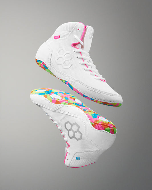 White wrestling shoes with colorful soles on a gray background