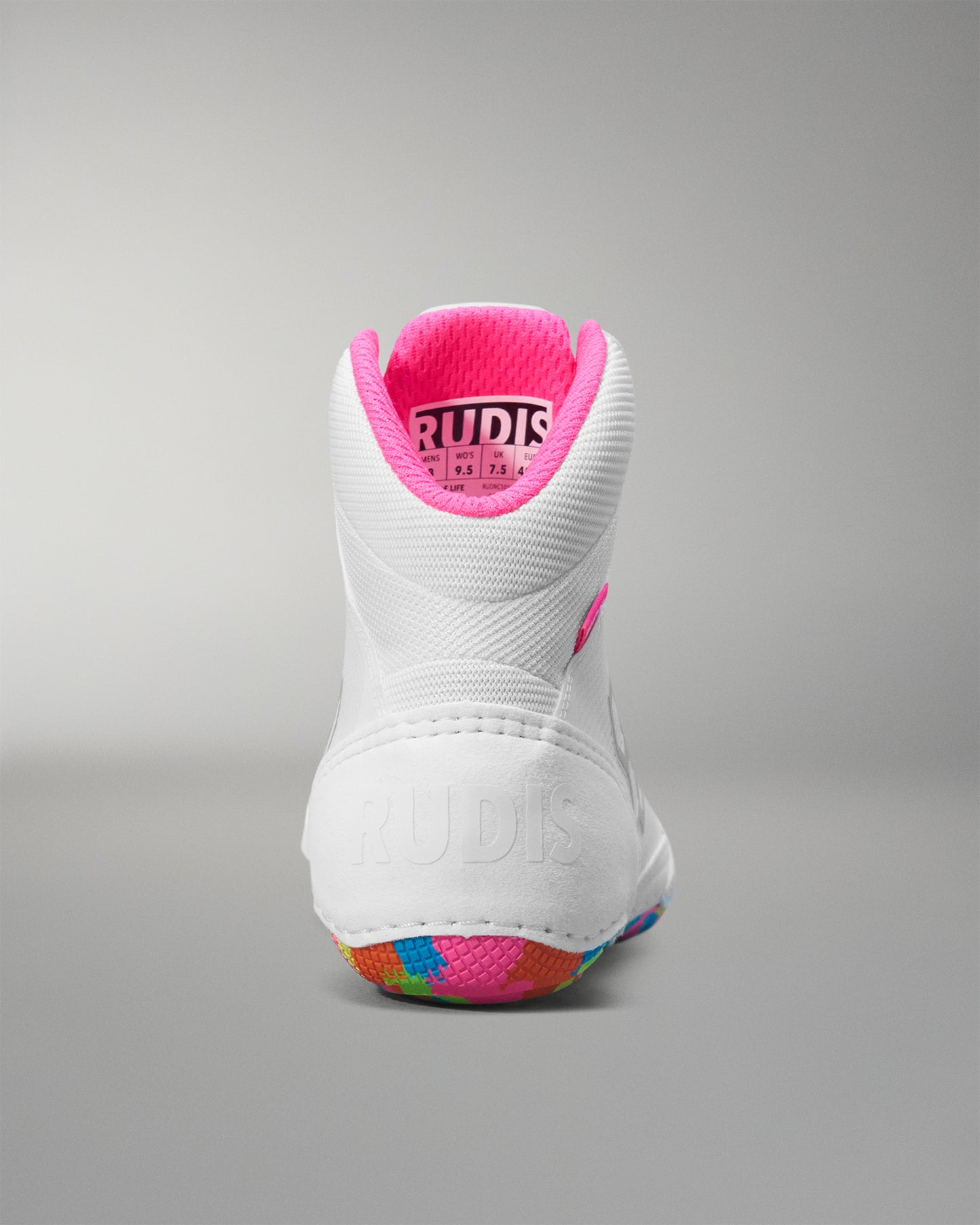 White wrestling shoe with pink interior on a gray background