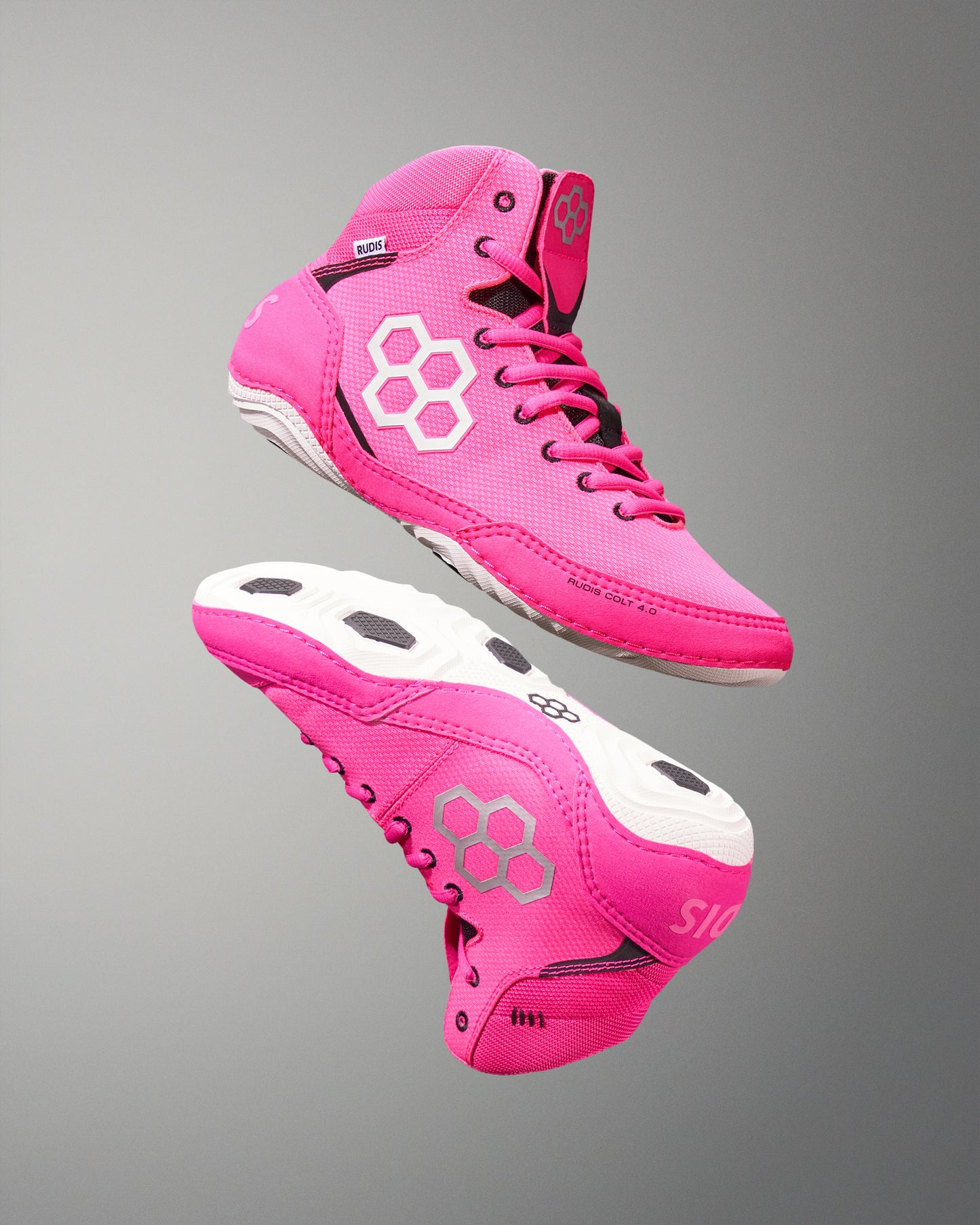 Pink athletic shoes with a white logo on a gray background