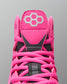 Close-up of a pink sports shoe with a brand logo on a gray background