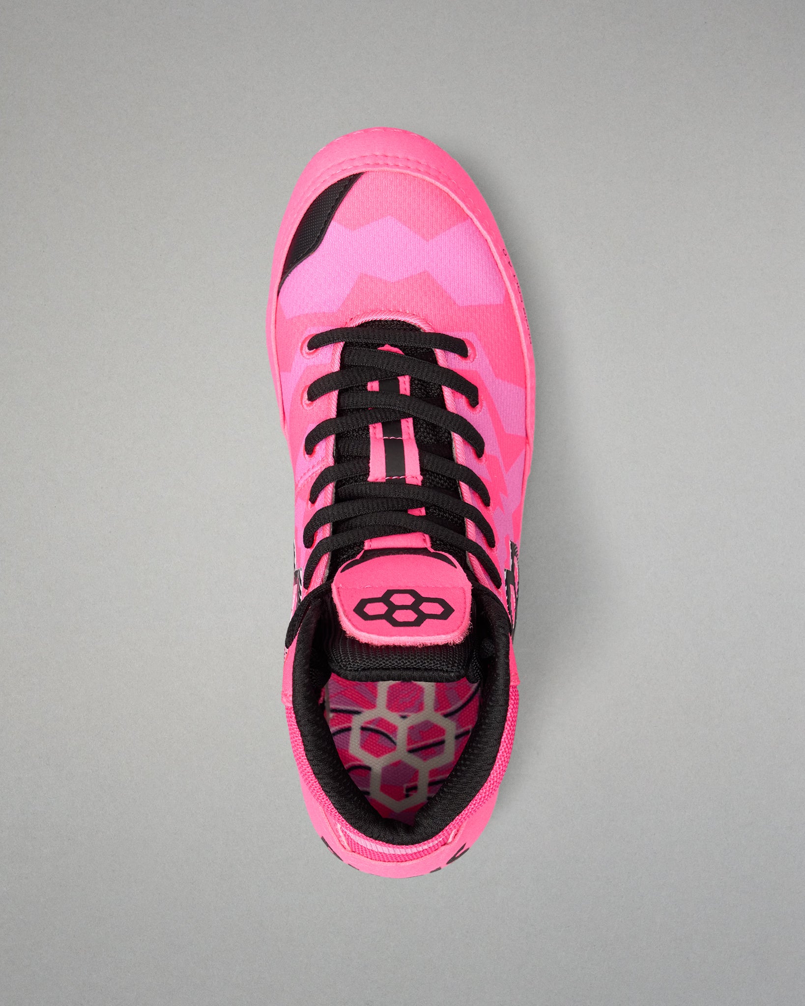 A single high-top Wrestling shoe in vibrant pink with a tonal pink and black chevron pattern, black laces, and a black and pink honeycomb-patterned lining, shown from a top-down view on a neutral gray background.