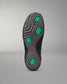 Black wrestling shoe sole with green hexagonal patterns on a gray background