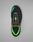 Black wrestling shoe with green and red accents on a gray background
