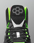 Black wrestling shoe with green accents and a brand logo on a gray background