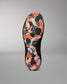 The outsole of a black Wrestling shoe featuring a vibrant orange, gray, and white geometric camouflage pattern, shown against a neutral gray background.