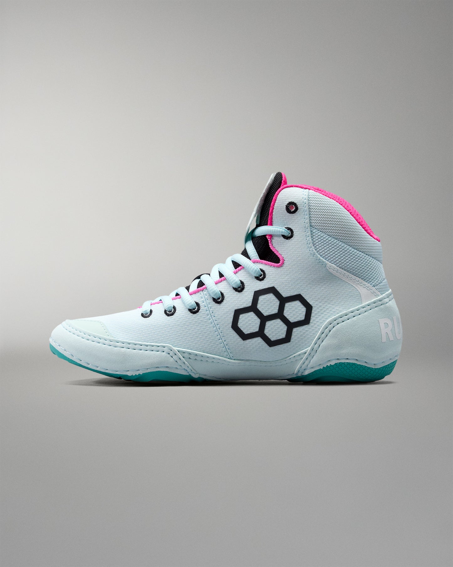 White high-top sneaker with pink accents on a gray background
