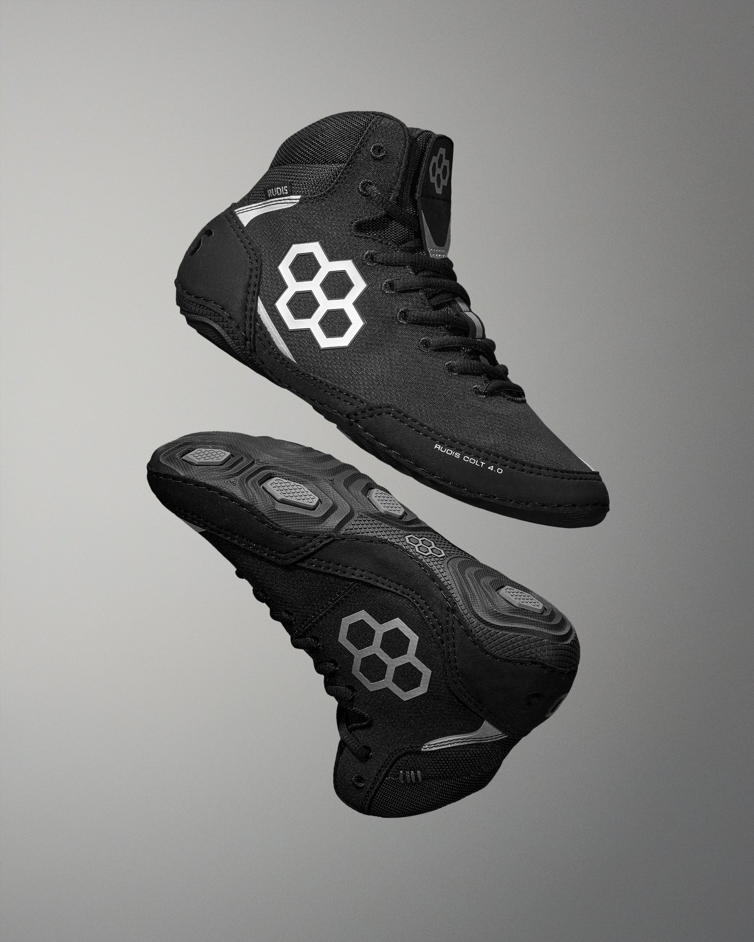 Black Wrestling Shoes with a geometric logo on a gray background