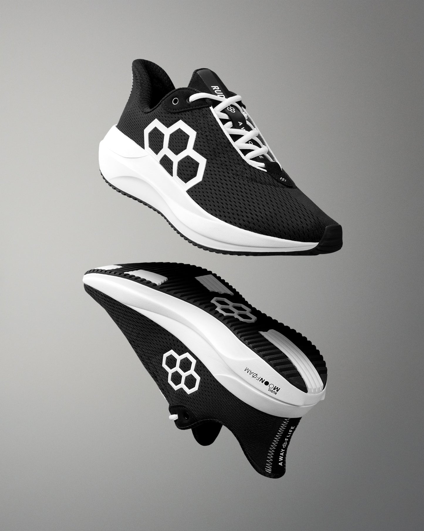 Black and white running shoes with a geometric design on a gray background