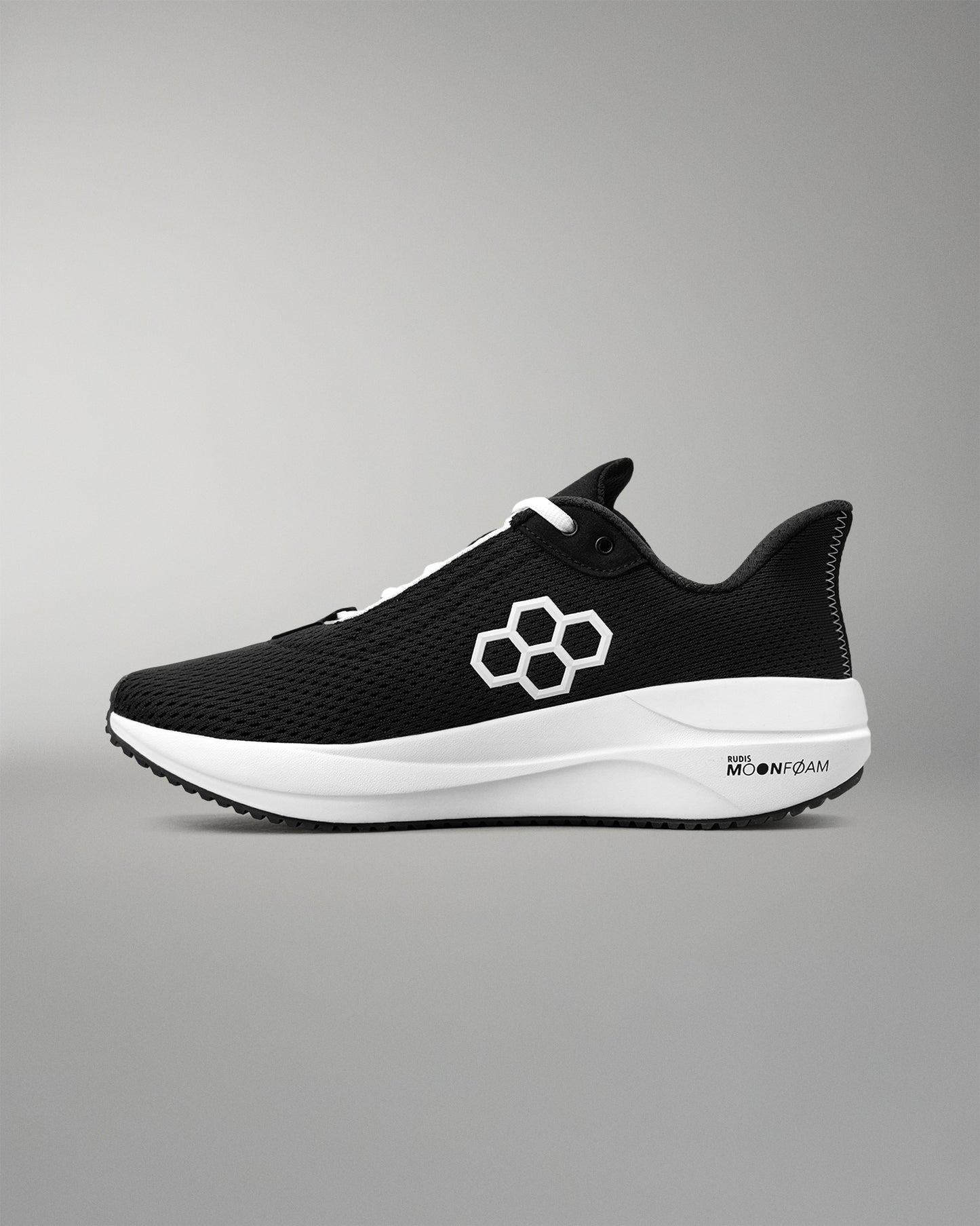 Black running shoe with a white sole on a gray background