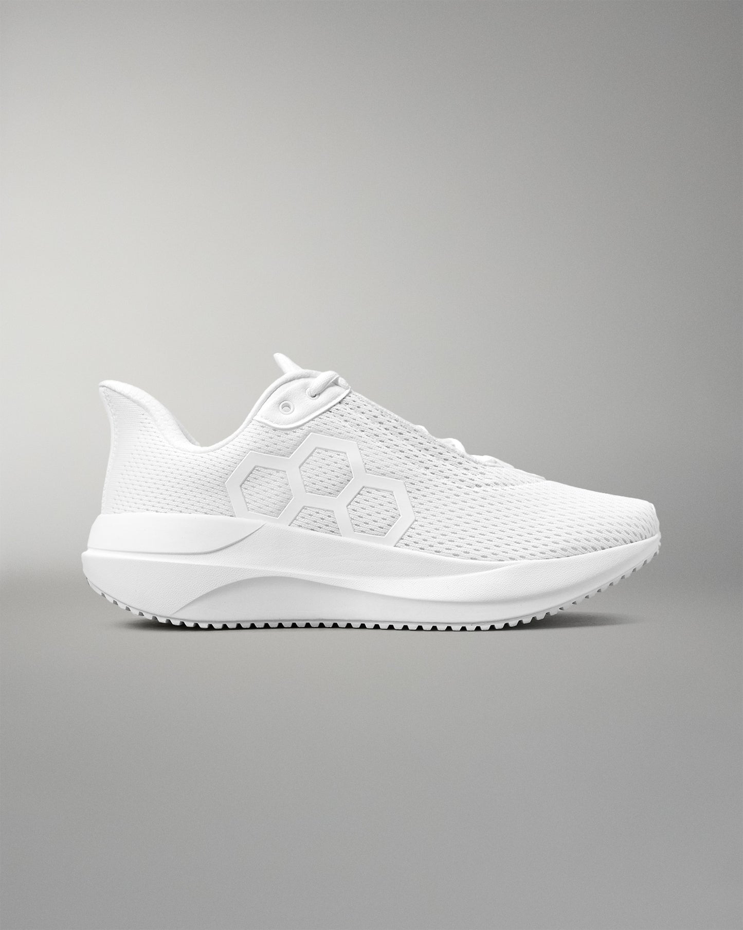 White athletic shoe on a gray background