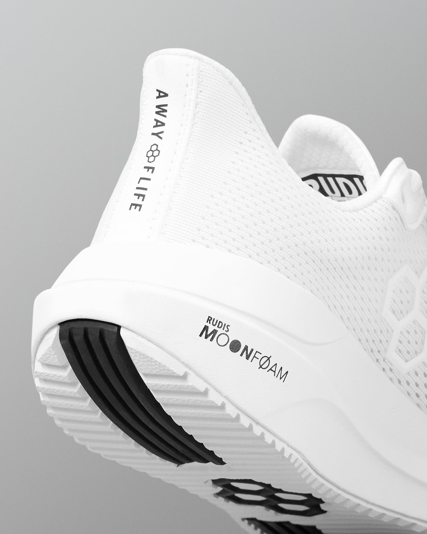 White athletic shoe with branding on a gray background