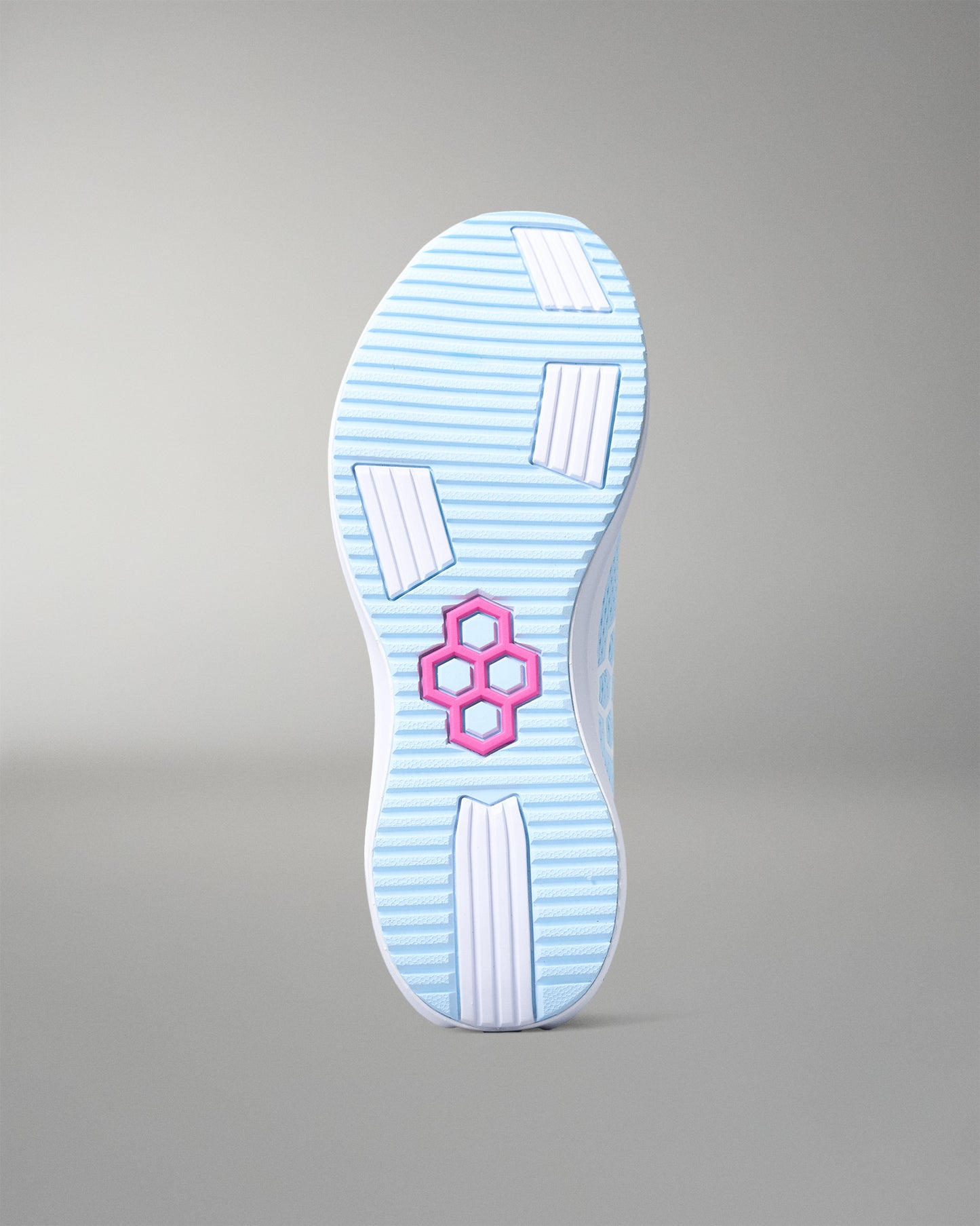 Sole of a shoe with a pink logo on a gray background