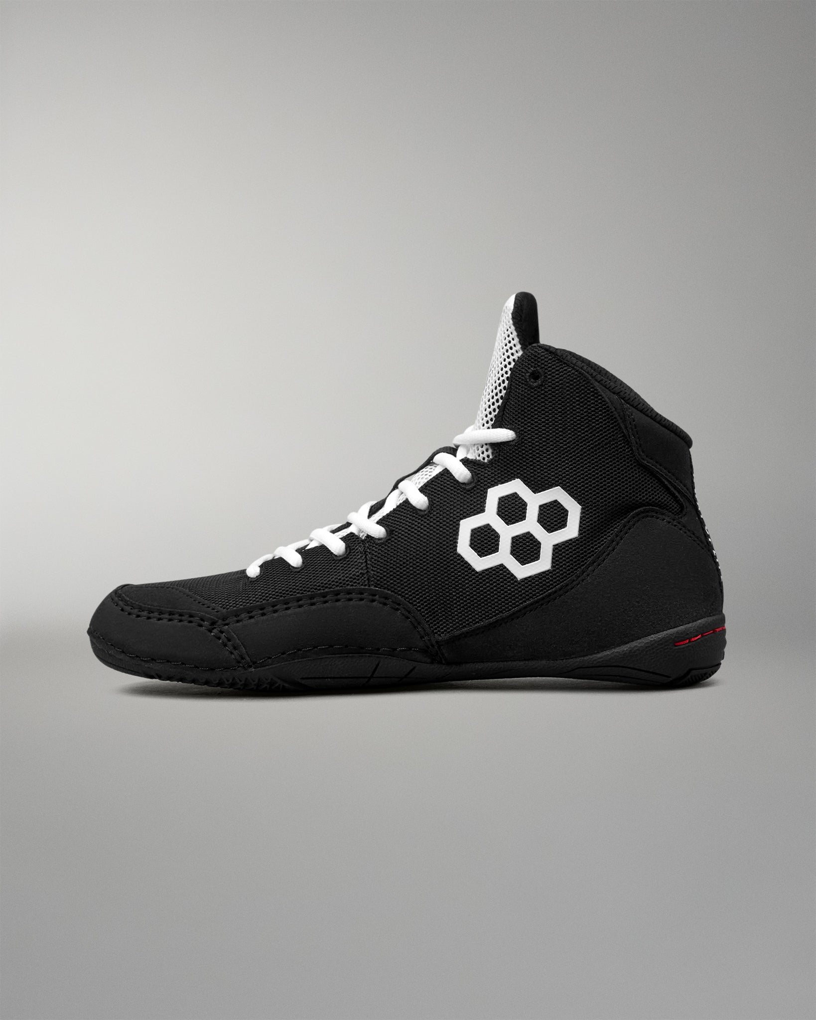 Black wrestling shoe with RUDIS branding on a light gray background