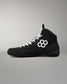 Black wrestling shoe with RUDIS branding on a light gray background
