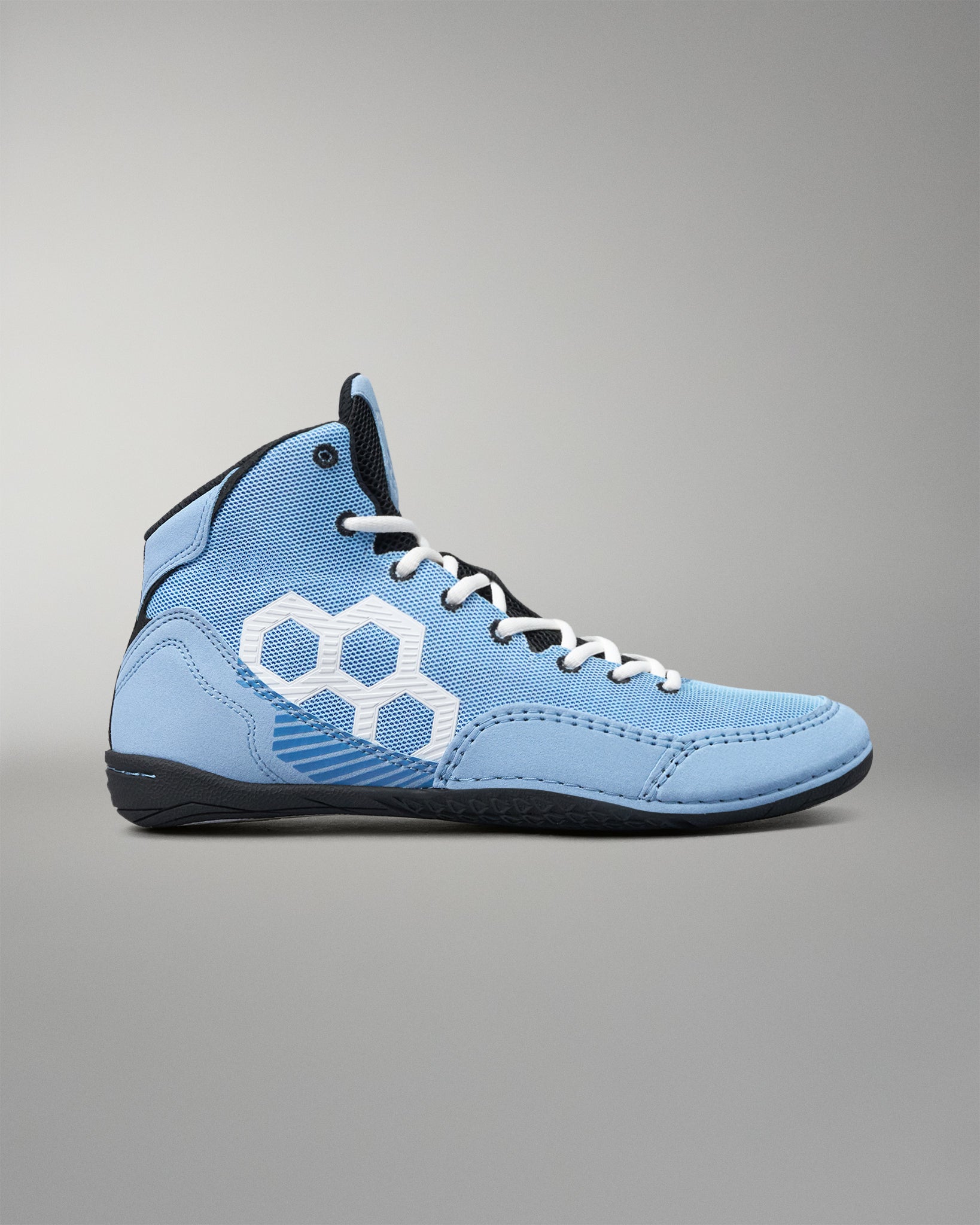 A light blue high-top wrestling shoe with white laces, a white geometric side logo, and a black sole, photographed against a neutral gray background.