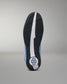 The outsole of a light blue and black wrestling shoe, showing a textured black tread pattern with a white center stripe and a circular blue and white logo on the heel.