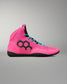A high-top wrestling shoe in vibrant pink with a black geometric hexagon logo on the side, turquoise laces, and a black sole, shown against a neutral gray background.