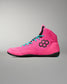 A high-top wrestling shoe in bright pink with turquoise laces, a black hexagonal logo on the side, and a black sole, shown against a neutral gray background.