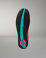 The outsole of a wrestling shoe shown from the bottom, featuring a black textured tread with a prominent bright turquoise center stripe and a circular logo patch in turquoise and hot pink at the heel.