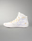 A high-top wrestling shoe in white with gold accents, including a wavy gold stripe on the laces, a gold flower logo on the side, and gold script text, shown against a neutral gray background.
