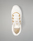 A white wrestling shoe with gold accents, including the laces and branding, shown from a top-down view on a neutral gray background.