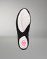 The outsole of a black and white athletic wrestling shoe, showing a textured white tread pattern with a pink geometric logo near the heel, set against a neutral gray background.